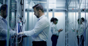 Engineers work with cables in the server room - Texas Hotel and Lodging